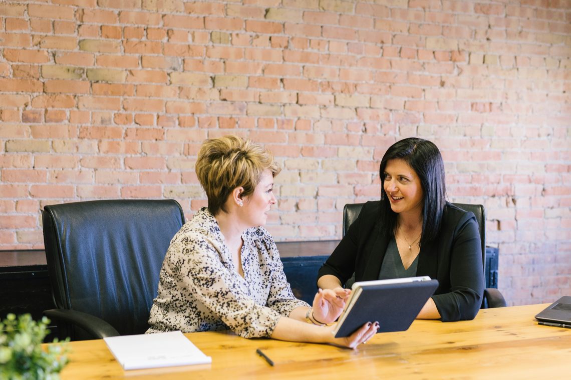 two ladies sitting at a desk
